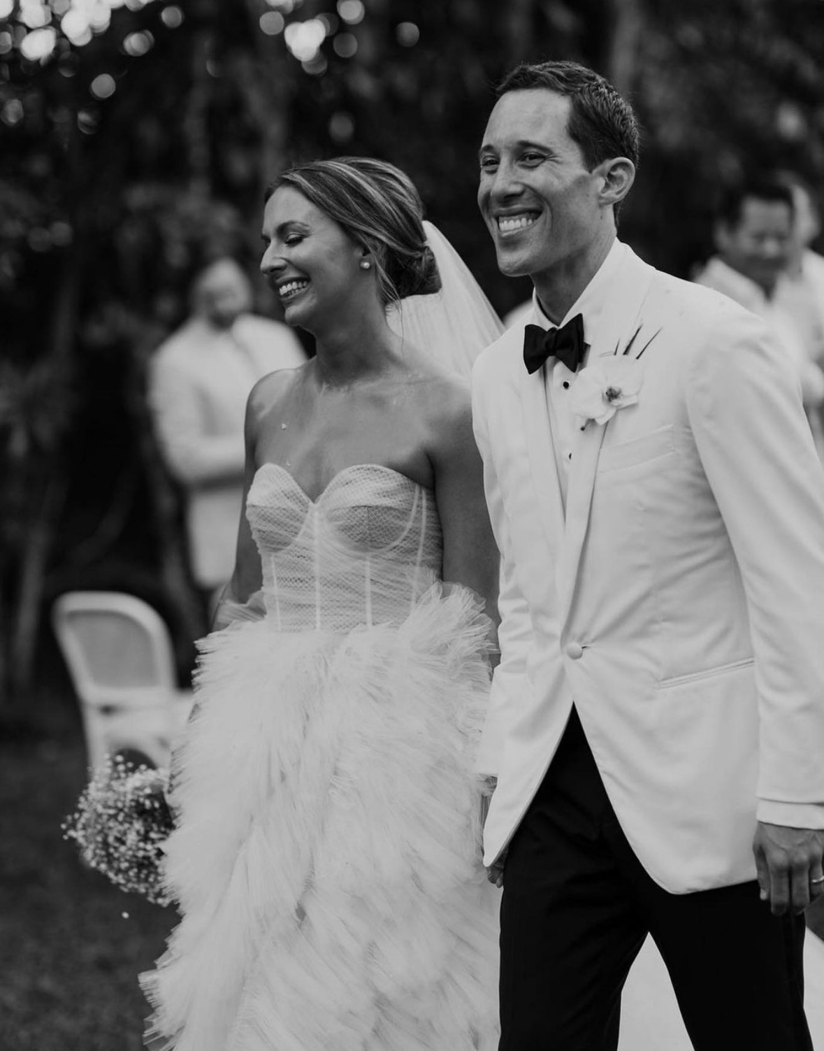 Bride and groom walking, black and white.